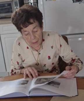 Author leafing through her book.