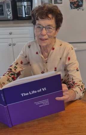Author enjoying a first look at her celebration book.